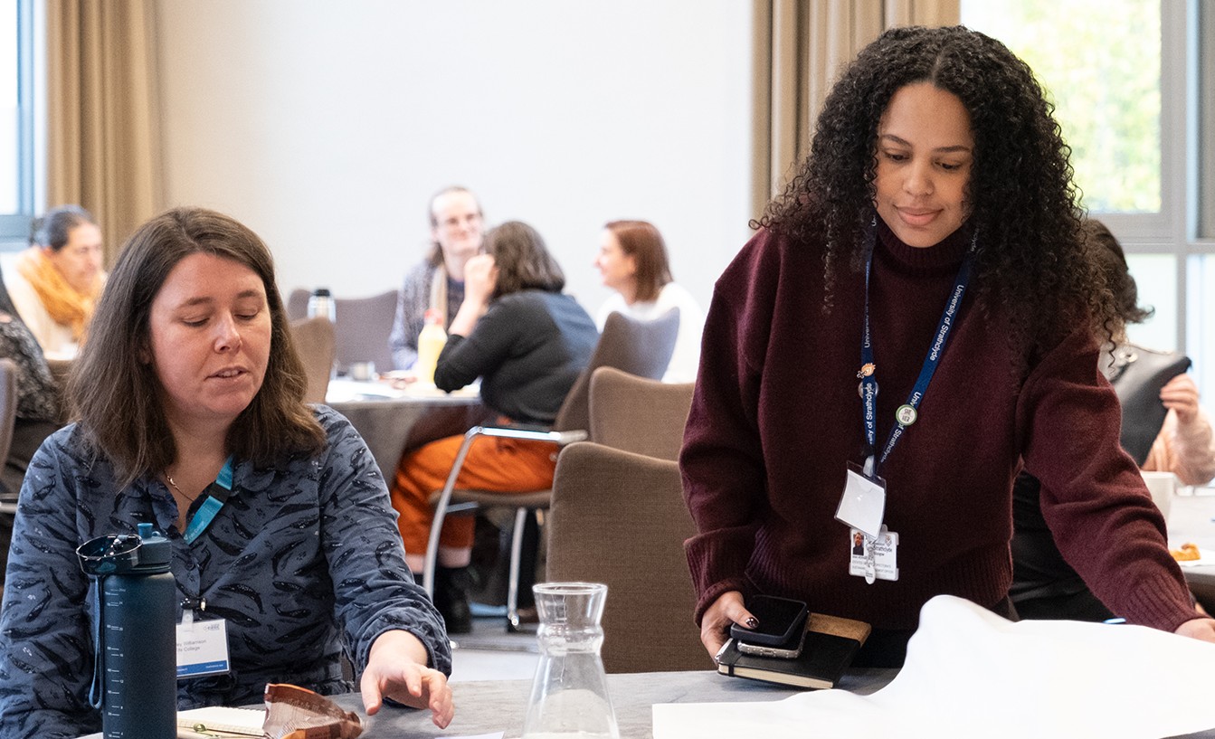 Two people working together during a conference session. 